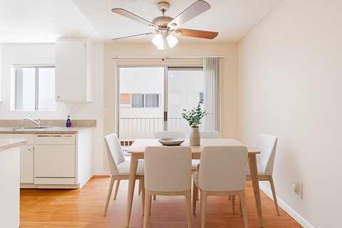 A dining room with a table set for four.